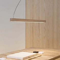 a wooden table with a light hanging over it