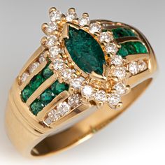 This pretty ring is centered with one (1) marquise cut emerald weighing 0.42 carats that is set in two (2) chevron shaped prongs. Surrounding the center stone are eighteen (18) round brilliant cut diamonds that are all prong set. The shoulders of the ring each contain six (6) round brilliant cut diamonds that are channel set and six (6) round cut emeralds that are also channel set. The ring measures 17.0mm at the top, rises 7.8mm above the finger, tapering to 3.0mm wide and 1.0mm thick at the base of the shank. It is currently a size 10. Two of the diamonds are lightly chipped. Marquise Brilliant Cut Emerald Ring, Marquise Emerald Ring With Brilliant Cut, Marquise Emerald Diamond Ring, Marquise Emerald Ring With Center Stone, Classic Formal Marquise Emerald Ring, Classic Formal Emerald Marquise Ring, Emerald Diamond Ring For May Birthstone In Marquise Shape, Green Marquise Diamond Ring For Formal Occasions, Green Marquise Diamond Ring For Formal Events