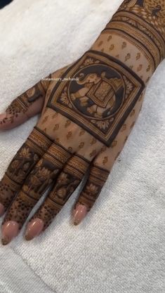 the hand is decorated with intricate designs on it