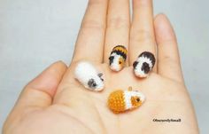 four miniature animals are placed in the palm of someone's hand as if they were crocheted