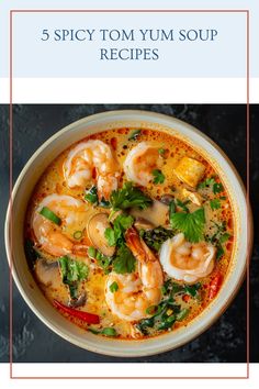 a bowl filled with shrimp and vegetables on top of a black table next to a red frame