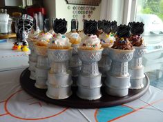 cupcakes are lined up in the shape of lighthouses on top of each other