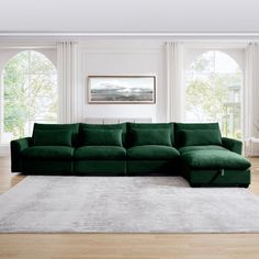 a large green sectional sofa in a living room with hardwood flooring and white walls