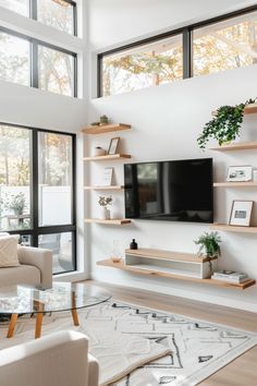 a living room filled with furniture and a flat screen tv on top of a wooden shelf