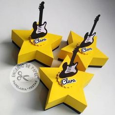 five yellow stars with black and white guitars on them