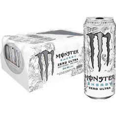 two cans of monster energy drink next to each other in front of a white box