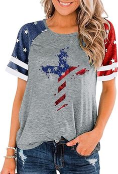 a woman wearing an american flag t - shirt with the cross in red, white and blue