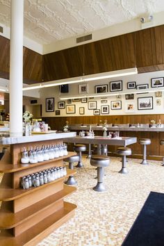 the inside of a restaurant with many tables and stools