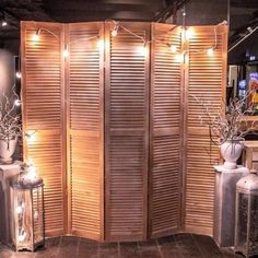 a room divider made out of wooden slats and decorated with lights on the sides