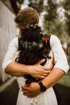 a man and woman hugging each other outside