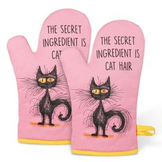 two oven mitts with cats on them that say the secret ingredient is cat hair