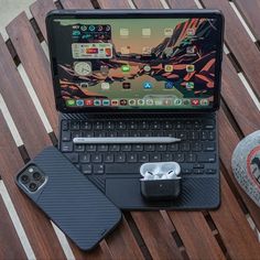 an open laptop computer sitting on top of a wooden table next to a pair of shoes