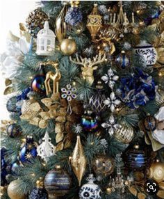 a blue and gold christmas tree with ornaments