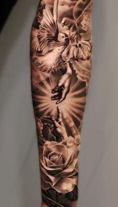 a man's arm with an angel and roses tattoo on it