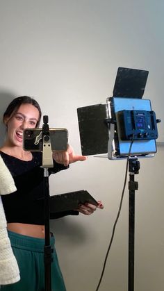 a woman standing in front of a camera