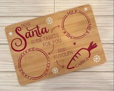 a wooden cutting board with some words on it and snowflakes around the edges