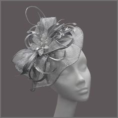 Ladies metallic silver disc fascinator (hatinator) with sinamay loops, feathers and a gorgeous crystal flower centre. Made on a headband. This design can be made to order, please contact us for details. Perfect for a tea party, wedding (mother of the bride), race day or for a special occasion. Designs can be made to order in a range of different colours or styles, see our colour chart: www.jacquivaledesigns.com/colour_chart.html Please contact me if you would like a design in a different colour. Silver Headband Fascinator For Party, Silver Headband For Party, Silver Adjustable Hair Accessories For Formal Occasions, Elegant Silver Hat For Evening, Adjustable Silver Headband Fascinator, Silver Headband For Evening Wear, Elegant Adjustable Silver Headpieces, Adjustable Silver Headband For Evening, Silver Headband For Evening