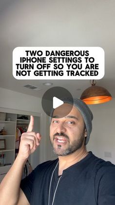 a man with headphones on pointing at the camera and two dangerous signs above him