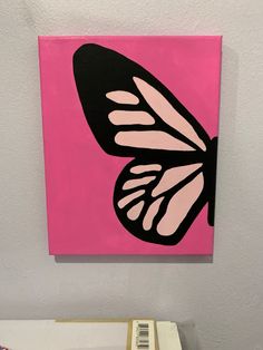 a pink and black butterfly on a pink background