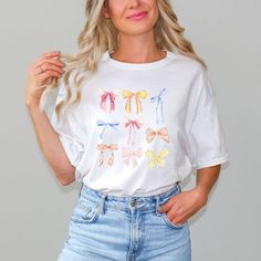 Looking for a cute versatile top to wear? Make sure to grab one of our Graphic tees! This soft and comfortable graphic tee is the perfect top for any outfit. It can be paired with biker shorts, jeans, or even a simple skirt/dress! This tee is true-to-size, so be sure to order your regular t-shirt size! If you are looking for a more oversized look, make sure to size up! White T-shirt With Funny Print For Spring, Spring Funny Print Graphic Tee, Funny Print Graphic Tee For Spring, Cute Spring Tops With Screen Print, Cute Tops With Screen Print For Spring, Cute Screen Print Tops For Spring, Cute White T-shirt For Spring, White Top With Funny Print For Spring, Spring White Pre-shrunk T-shirt