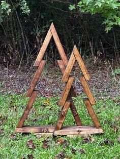 three wooden triangulars sitting in the grass