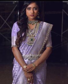 a woman in a purple sari and jewelry