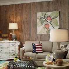 a living room filled with furniture and a painting on the wall above it's headboard