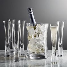 an assortment of glasses and bottles with ice in them