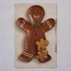 a ceramic ginger man and two teddy bears on a tile wall hanging ornament