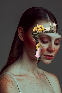 a woman with freckled skin and flowers in her hair