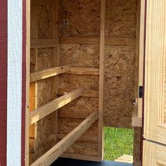 the inside of a wooden trailer with its door open