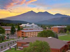 an aerial view of a campus with mountains in the background