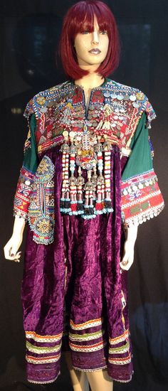 "Rare size and Rare dress. Kuchi wedding Dress, saturated with intricate hand beaded tassles, Old silver coins (some date to 1948) Beaded Medallions, genuine coins,. Cotton Sleeves. Flared wide long sleeves. Elaborate decorated one side pocket. Weighs a hefty 8 lbs almost. Measures: 45\" around bust. 18\" across the shoulders. About 48\" from shoulder to hem." Bohemian Dresses With Traditional Patterns For Transitional Season, Transitional Bohemian Dresses With Traditional Drape, Bohemian Festive Ceremonial Dress, Ceremonial Bohemian Dresses, Bohemian Ceremonial Dress With Traditional Patterns, Tunic Dresses For Navratri Festival, Navratri Festival Tunic Dresses, Red Bohemian Dress For Transition Seasons, Bohemian Red Dress For Seasonal Wear