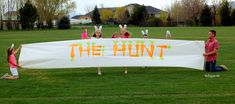 children holding up a sign with the words the hunt written on it in front of them