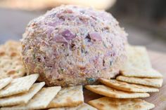 a ball of meat and crackers on a cutting board