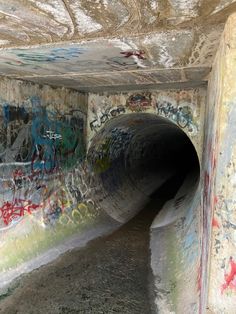 a tunnel with graffiti all over it