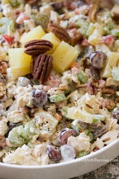 a white bowl filled with salad and fruit