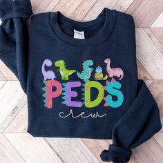 a child's sweatshirt with the words pepps on it and dinosaurs in colorful letters