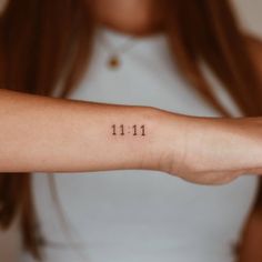 a woman's arm with the number 11 on it, in front of her