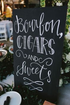 a sign that says bourbon cigars and sweet s on the side of a table