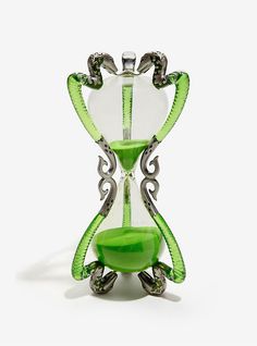 an hourglass with green glass and silver accents