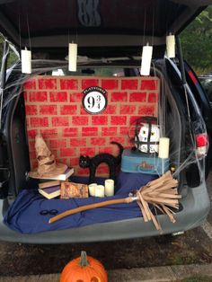 the trunk of a car is filled with halloween decorations