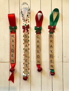 three christmas ribbons are hanging on the wall