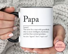 a woman holding a coffee mug with the words grandad on it in black and white