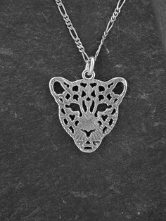 "This Leopard pendant is Sterling Silver. The included chain is a Sterling Silver Figaro 50 chain. You may choose 16, 18 or 20 inch at the same price. Other length available at sightly higher prices. This Leopard pendant measures 1 1/8\" tall by 1\" across. I hand cast all my pieces using the lost wax casting method. Please ask your needs. You may call me with questions, often I am out so please use my machine. 831-476-3176. Satisfaction Guaranteed! I send items USPS First Class unless otherwise Metal Charm Necklace With Figaro Chain As Gift, Silver Figaro Chain Pendant Jewelry, Silver Figaro Chain Pendant Necklace, Silver Figaro Chain Jewelry With Round Pendant, Silver Pendant Necklace With Figaro Chain, Silver Jewelry With Figaro Chain And Round Pendant, Leopard Head, Silver Wolf, Wax Casting