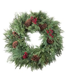 a christmas wreath with pine cones and berries