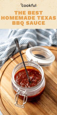 the best homemade bbq sauce in a glass jar on a wooden tray with a spoon