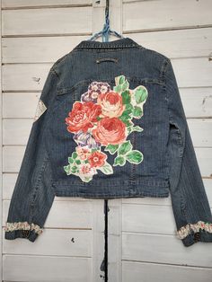 Women's denim stretch jacket.  Size Medium.  Uniquely upcycled with red floral embellishments using vintage trims, fabrics, etc.  All work is sewn by hand, including embroidery and crochet accents. Fitted Denim Jacket With Floral Print, Upcycled Long Sleeve Denim Jacket For Spring, Reworked Vintage Denim Jacket For Spring, Vintage Reworked Denim Jacket For Spring, Spring Upcycled Long Sleeve Denim Jacket, Spring Cotton Reworked Denim Jacket, Spring Reworked Cotton Denim Jacket, Fitted Upcycled Denim Jacket, Reworked Fitted Cotton Denim Jacket