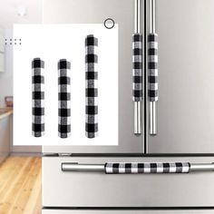 the refrigerator is decorated with black and white checkered magnets on it's doors