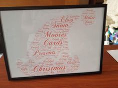 a framed christmas card with words written in different languages